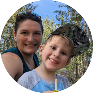 Profile picture of Elizabeth Williams and her son, outdoors with tall trees and blue skies in the background.