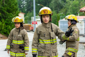 Youth in fire fighters suit attending a Indigenous Youth Career Camp