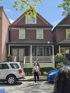 Melanie Meyers and Dave Smulders standing in front of a house in Strathcona's East Vancouver neighbourhood.