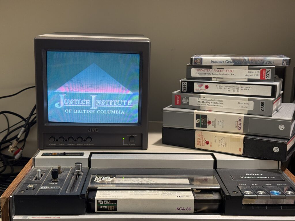 Picture of an old tv with video tapes stacked beside