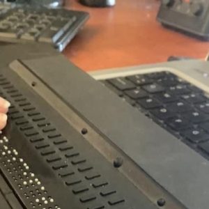 Jen reading a line of text on a 40-cell/40-characters refreshable braille display for one of her classes