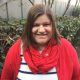 profile picture of Krista in a red sweater and red scarf and cute striped top.