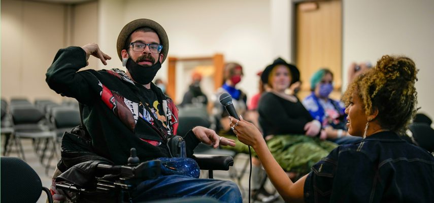 Disabled student using assistive technology to participate in class